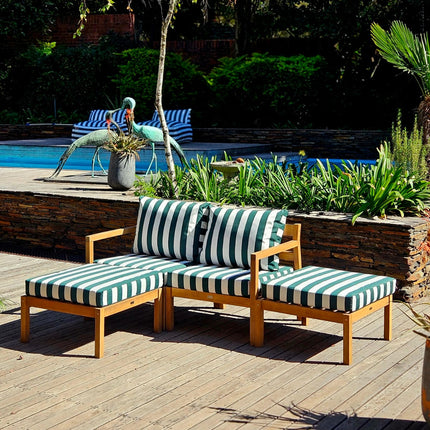 Outdoor patio set with green striped cushions by a poolside
