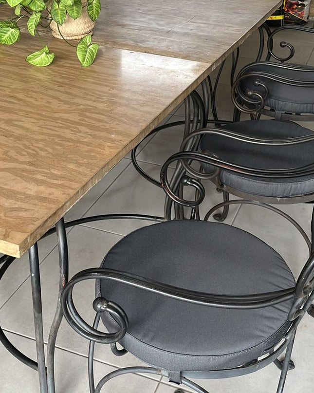 Dining area with wooden table and metal chairs in a home setting.