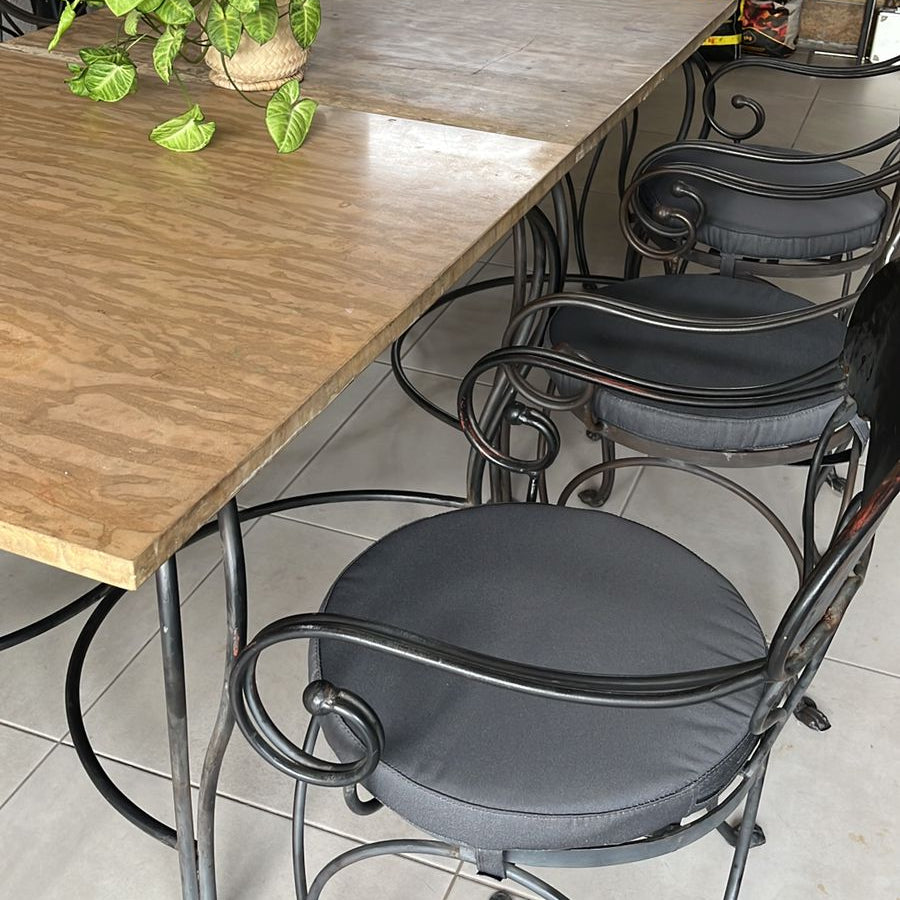 Dining area with wooden table and metal chairs in a home setting.